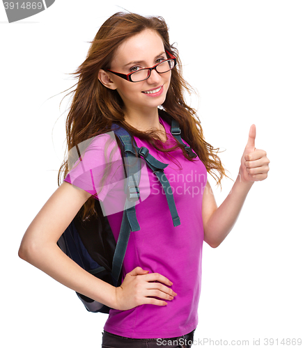 Image of Young student girl is showing thumb up sign