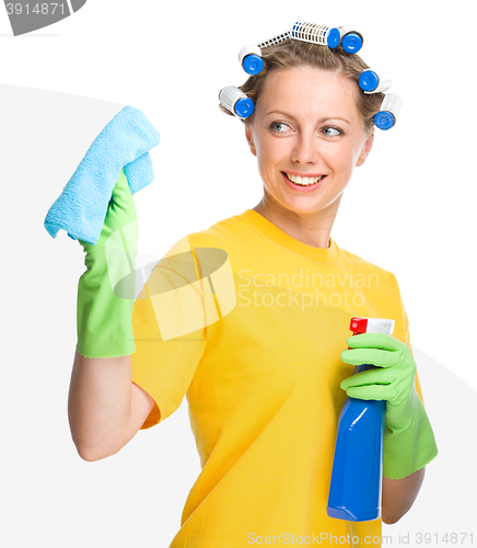 Image of Young woman is cleaning glass using rag