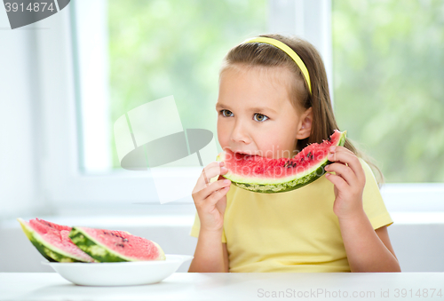 Image of Cute little girl is eating watermelon