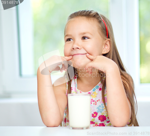 Image of Cute little girl with a glass of milk