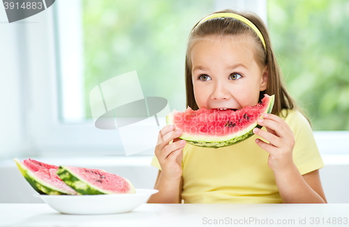 Image of Cute little girl is eating watermelon