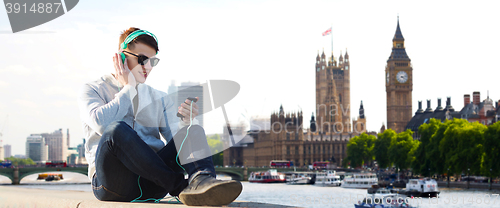 Image of happy young man in headphones with smartphone