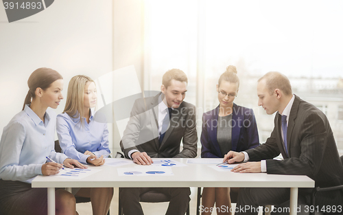 Image of business team with documents having discussion