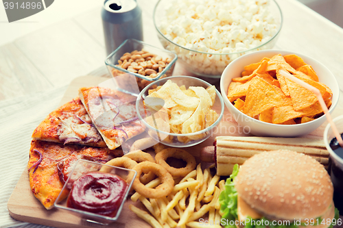 Image of close up of fast food snacks and drink on table