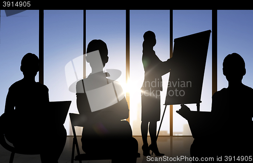 Image of business people silhouettes at meeting in office