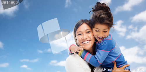 Image of hugging mother and daughter over sky background