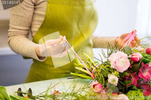 Image of close up of woman making bunch at flower shop