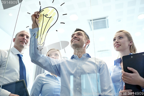 Image of smiling business people with marker and stickers