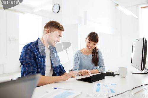 Image of creative team with tablet pc and papers at office