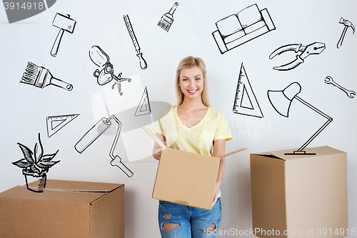 Image of smiling young woman with cardboard box at home