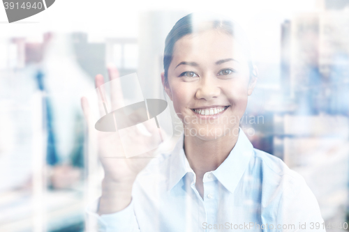 Image of group of smiling businesspeople meeting in office