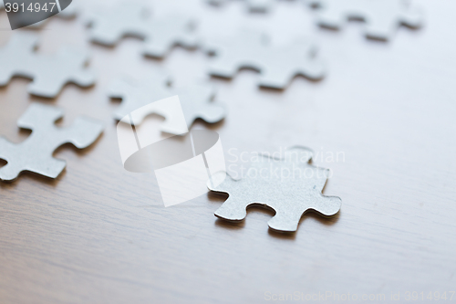 Image of close up of puzzle pieces on wooden surface