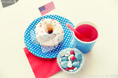 Image of donut with juice and candies on independence day