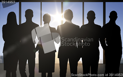 Image of business people silhouettes over office background