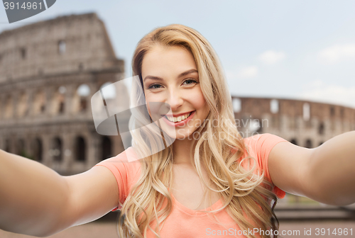 Image of happy smiling young woman taking selfie