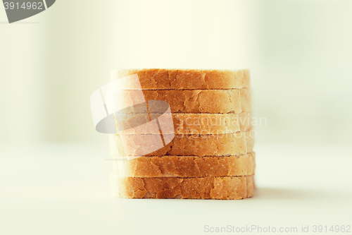 Image of close up of white sliced toast bread pile on table