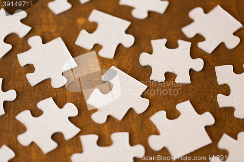 Image of close up of puzzle pieces on wooden surface