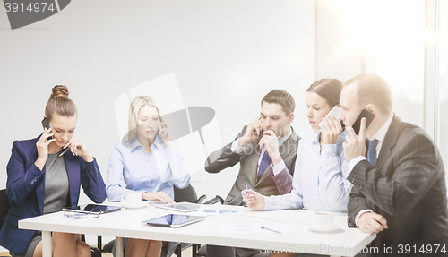 Image of business team with smartphones having conversation