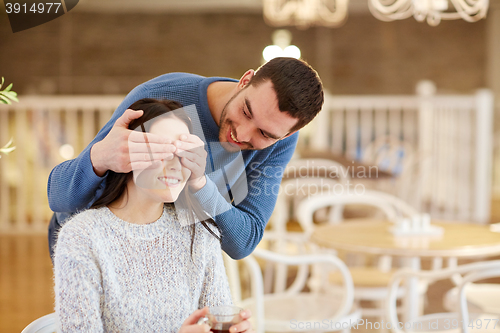 Image of happy couple drinking tea at cafe