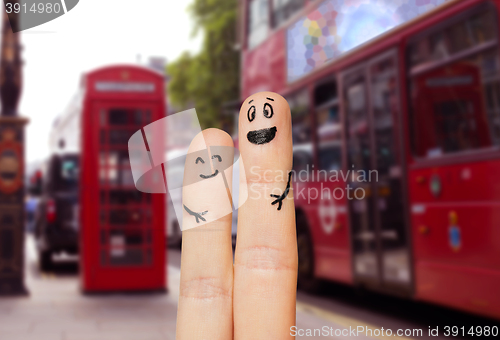 Image of close up of two fingers with smiley faces