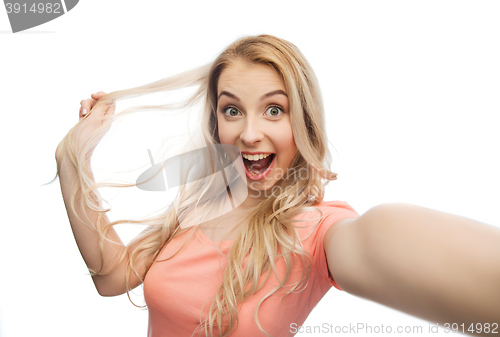 Image of smiling young woman taking selfie