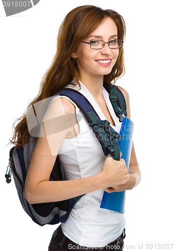 Image of Young student girl is holding book