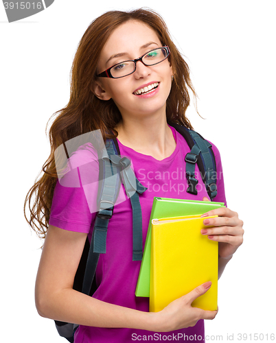 Image of Young student girl is holding book