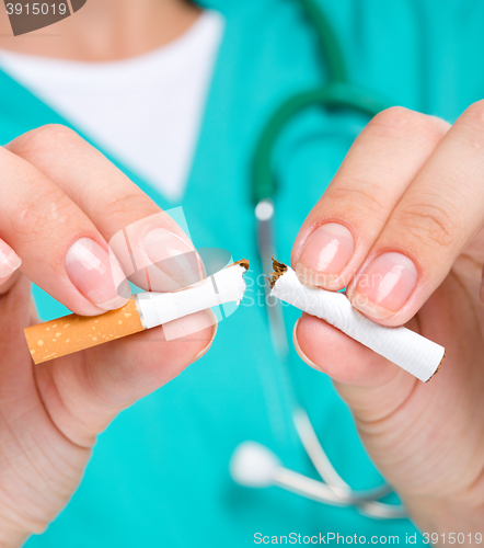 Image of Doctor in uniform breaks cigarette