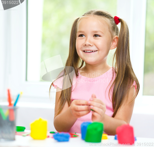 Image of Girl is having fun while playing with plasticine