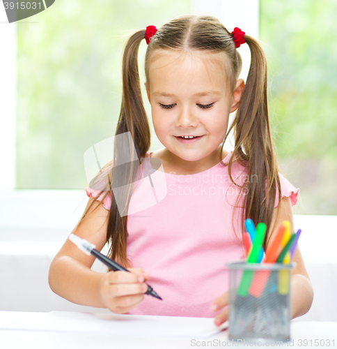 Image of Cute cheerful child drawing using felt-tip pen