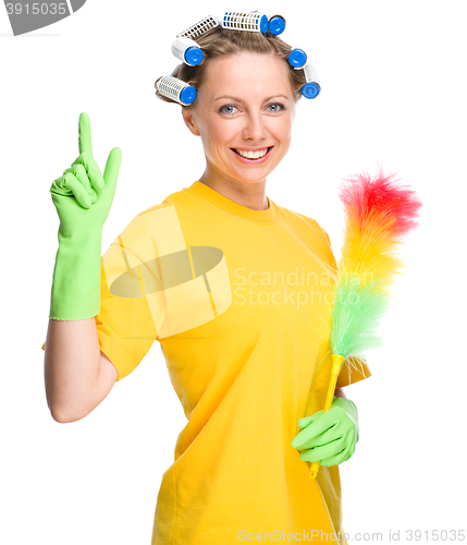 Image of Young woman holding static duster