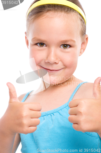 Image of Little girl is showing thumb up gesture