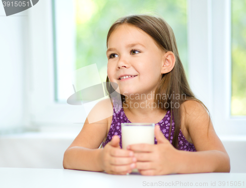 Image of Cute little girl with a glass of milk