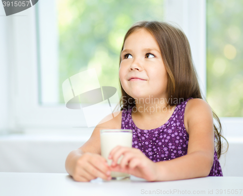 Image of Cute little girl with a glass of milk