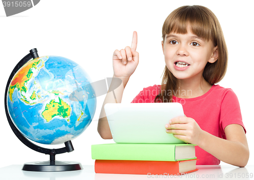 Image of Young girl is using tablet