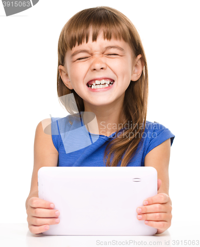 Image of Young cheerful girl is using tablet