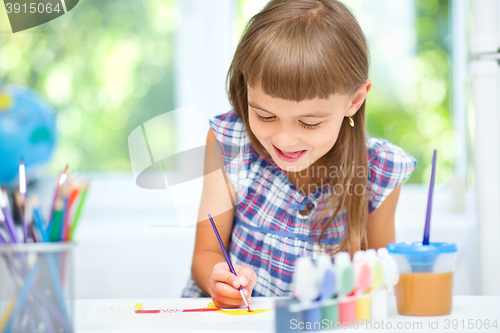 Image of Little girl is painting with gouache