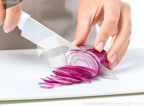 Image of Cook is chopping onion