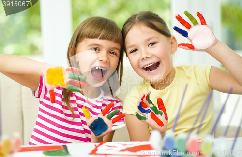 Image of Little girls are painting with gouache