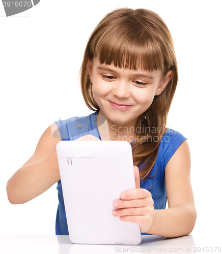 Image of Young girl is using tablet