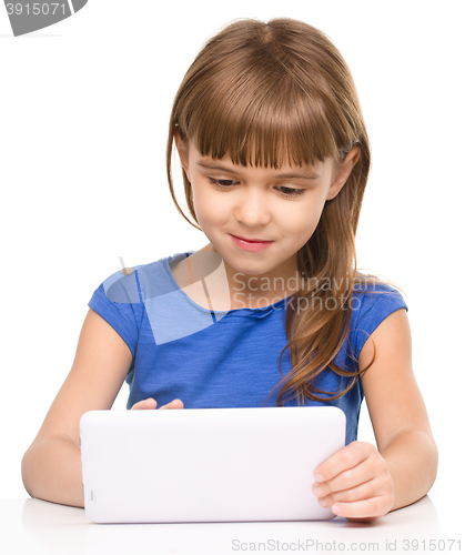 Image of Young girl is using tablet