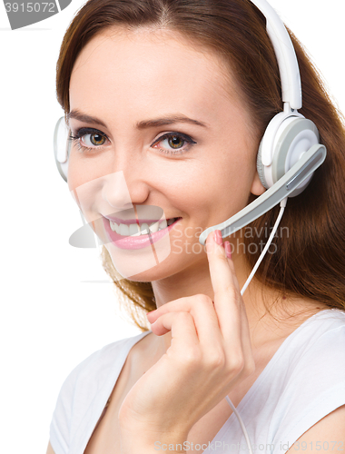 Image of Lovely young woman is talking to customers