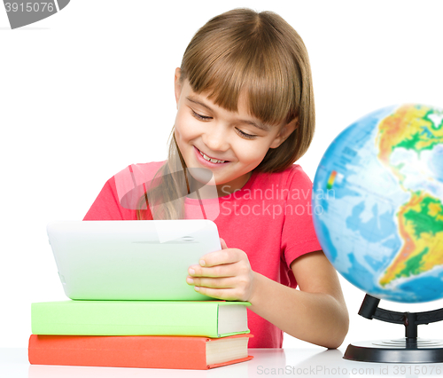 Image of Young girl is using tablet