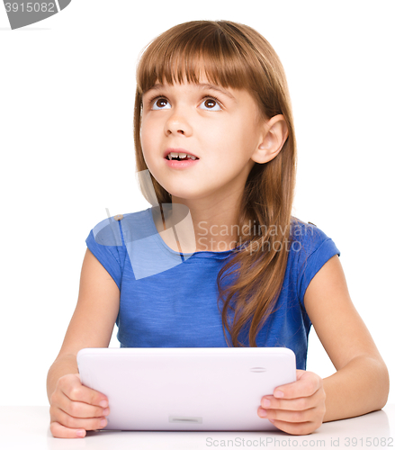 Image of Young girl is using tablet