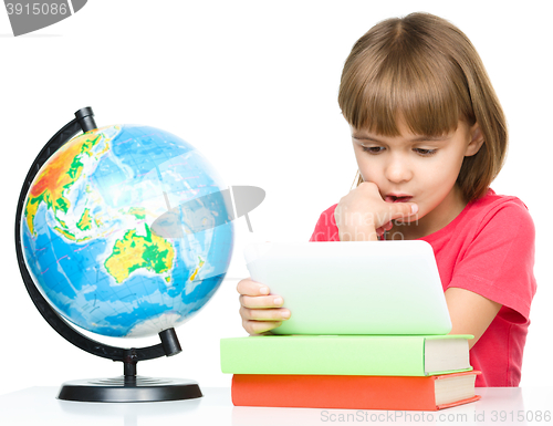 Image of Young girl is using tablet