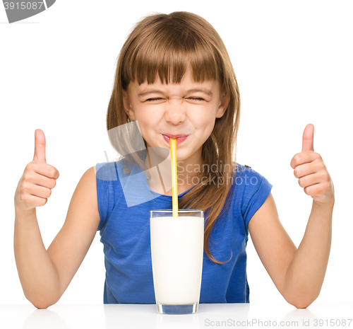 Image of Cute little girl with a glass of milk