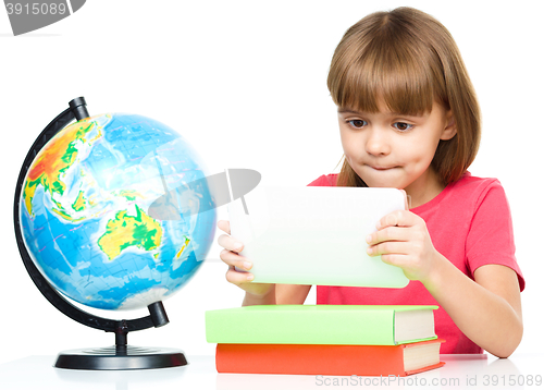 Image of Young girl is using tablet