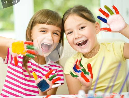 Image of Little girls are painting with gouache