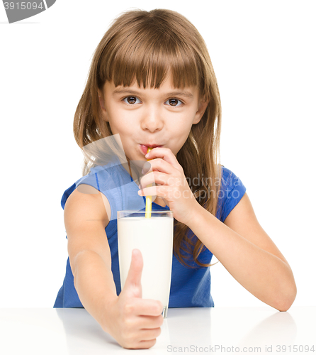Image of Cute little girl with a glass of milk