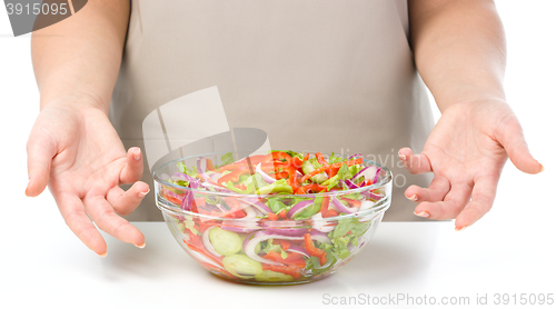 Image of Cook is presenting fresh salad